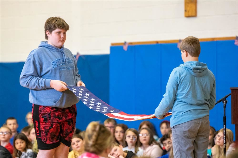  APW students fold the flag